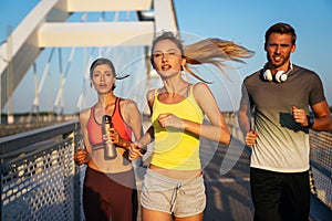 Fitness sport people running lifestyle concept. Group of young people jogging together outdoors.