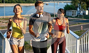 Fitness sport people running lifestyle concept. Group of young people jogging together outdoors.