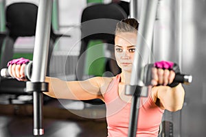 Fitness, sport, powerlifting and people concept - sporty woman doing workout in gym.