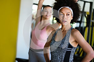 Fitness, sport, training, gym and lifestyle concept. Group of women working out in gym