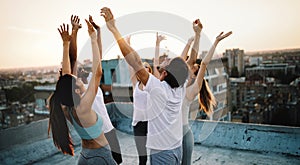 Fitness, sport, training and healthy lifestyle concept - group of happy people exercising outdoor