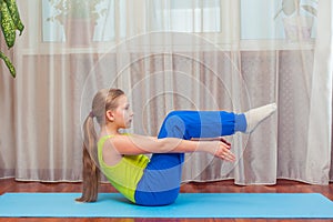 Fitness. sport, training and lifestyle concept - Child doing exercises on mat in home.