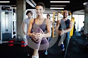 Fitness, sport, training and lifestyle concept. Group of people exercising in gym