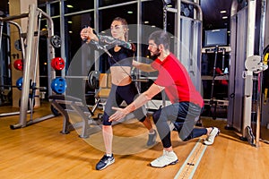 Fitness, sport, training and people concept - Personal trainer helping woman working with in gym