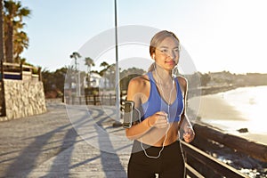 Fitness sport woman running on the beach shore