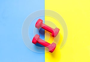 Fitness sports equipment top view, blue and yellow color background.