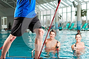 Fitness - sports gymnastics under water in swimming pool