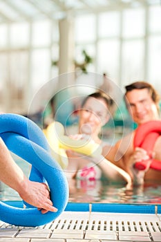 Fitness - sports gymnastics under water in swimming pool