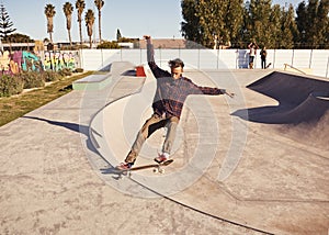 Fitness, sports and man with skateboard, jump or ramp action at a skate park for stunt training. Freedom, adrenaline and