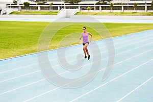 Fitness, sports woman and running on race track for athletics, sprint challenge or competition training in stadium