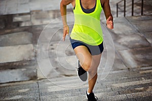 Fitness sports woman running up on city stairs