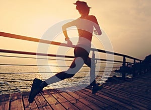 Fitness sports woman trail runner running on seaside