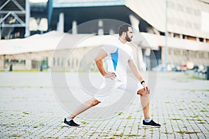 Fitness. Sportsman doing stretching exercises in park