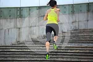 Fitness sporty woman running upstairs