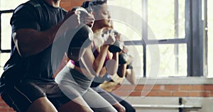 Fitness, squat and class with people in gym for workout, health and teamwork. Wellness, training and exercise with group