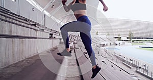 Fitness, stadium stairs and woman running for cardio practice, outdoor workout or sports commitment. Arena, concrete