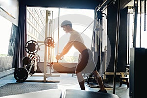 Fitness Strong Man Doing Heavy Weight Exercise on Machine in gym