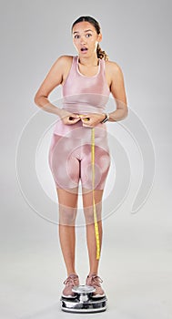 Fitness, tape and surprise with woman on scale in studio for weight loss, achievement and workout. Health, goal and