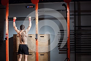 Fitness toes to bar man pull-ups bars workout exercise at gym