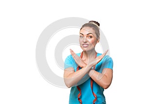 Fitness trainer wrinkles her nose and does forbiddening gesture with hands. Caucasian attractive woman with funny upset