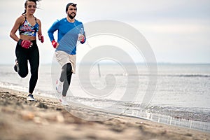 Fitness training before a boxing match.Man and woman running along beach together