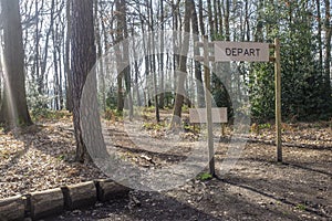 Fitness training in forest. Sign planted in a forest that indicates `Depart, Start` photo