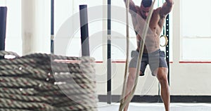 Fitness, training and man with rope in gym for exercise, weightlifting and bodybuilder workout. Sports, challenge and