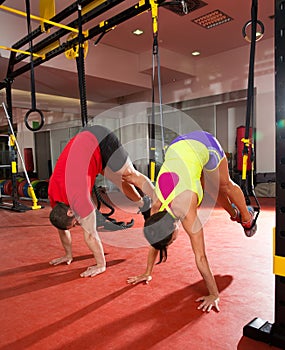 Fitness TRX training exercises at gym woman and man