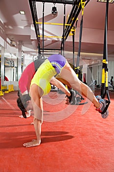 Fitness TRX training exercises at gym woman and man