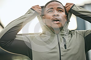 Fitness, vision and hoodie with a sports black man getting ready for a workout, exercise or running. City, health and