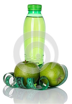 Fitness, weight loss concept with green apples, bottle of drinking water and tape measure isolated on white