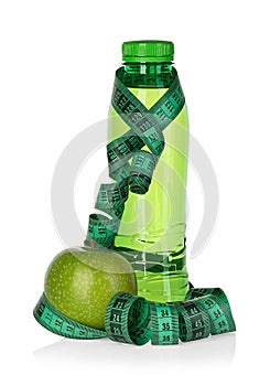 Fitness, weight loss concept with green apples, bottle of drinking water and tape measure isolated on white
