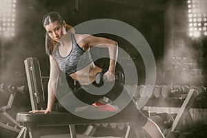 Fitness woman, Asian athletic woman pumping up muscles with dumbbells.
