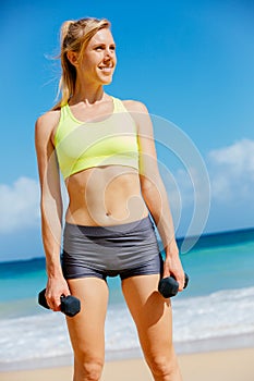 Fitness woman with barbells working out