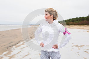 Fitness woman on the beach in winter