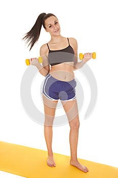 Fitness woman blue shorts weights curl smile