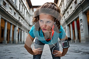 Fitness woman catching breathe near uffizi gallery in florence,