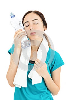 Fitness woman cooling herself with a bottle of cold water