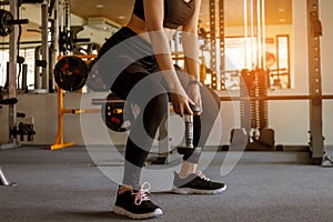 Fitness woman doing exercise workout with dumbbell at gym. lifestyle and exercise concept