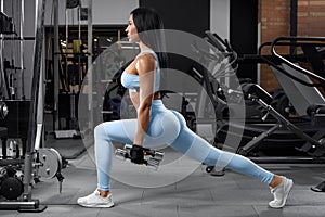 Fitness woman doing lunges exercises for leg muscle workout training. Active girl doing front forward one leg step lunge exercise