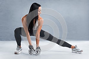 Fitness woman doing lunges exercises for leg muscle workout training. Active girl doing front forward one leg step lunge exercise