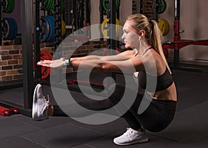 Fitness woman doing pistol squat photo