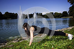 Fitness woman doing push-ups in the park