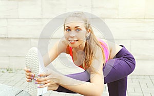 Fitness woman doing warm-up stretching exercise before run, female athlete ready to workout in city, sport and healthy lifestyle