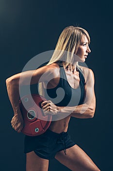 Fitness woman doing weight training by lifting a heavy weights
