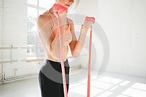 Fitness woman doing workout exercises resistance band