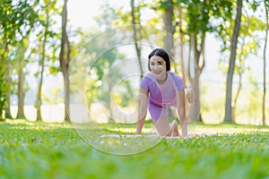 Fitness woman doing yoga in park, calm and relaxing women\'s happiness blurry background Asian woman