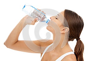 Fitness, woman and drinking water in studio for exercise break, energy and healthy detox on white background. Thirsty