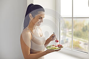 Fitness woman eating balanced healthy meal before or after workout