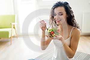 Fitness woman eating healthy food after workout